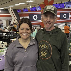 Couple standing together in bowling alley